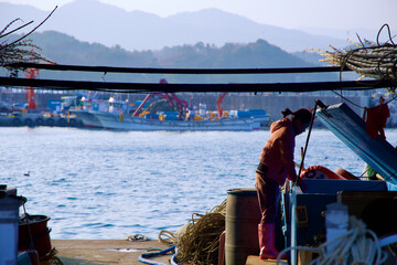 Fisherwoman Sorting Catch at Chogok Port