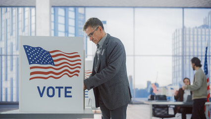 Respectable Adult Man Filling Out His Ballot. American People on the Elections Day in the United...