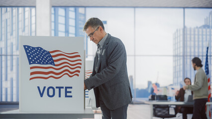 Respectable Adult Man Filling Out His Ballot. American People on the Elections Day in the United...