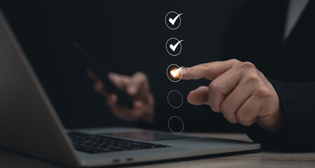 Performance checklist concept : businessman using finger with mobile phone for questionnaire, evaluation, assessment online or survey exam and filling out for digital survey and checklist	 - obrazy, fototapety, plakaty
