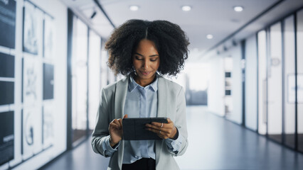 Portrait of a Young Empowered Black Female Business Manager Working on a Tablet Computer in a...