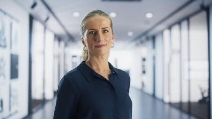 Portrait of an Adult Female in a Suit Posing for Camera, Smiling. Caucasian Businesswoman Standing...