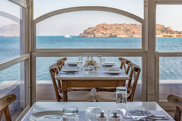 Plaka, Crete - October 16, 2019: View of Spinalonga Island from tavern on Crete, Greece.