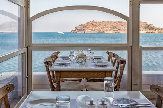 Plaka, Crete - October 16, 2019: View of Spinalonga Island from tavern on Crete, Greece.