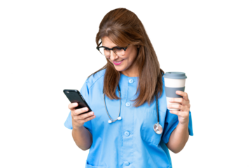 Middle age nurse woman over isolated background holding coffee to take away and a mobile