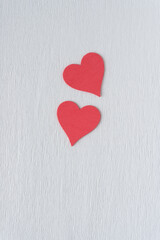 Naklejka na ściany i meble two pink hearts on blank crepe paper background