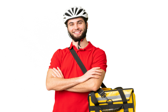 Young delivery man with thermal backpack over isolated chroma key background keeping the arms crossed in frontal position