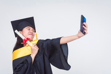 A proud young woman takes a selfie with her diploma. A successful graduate of bachelor of science...