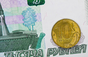 Money. 10 russian rouble coin and 1000 rubles banknote background