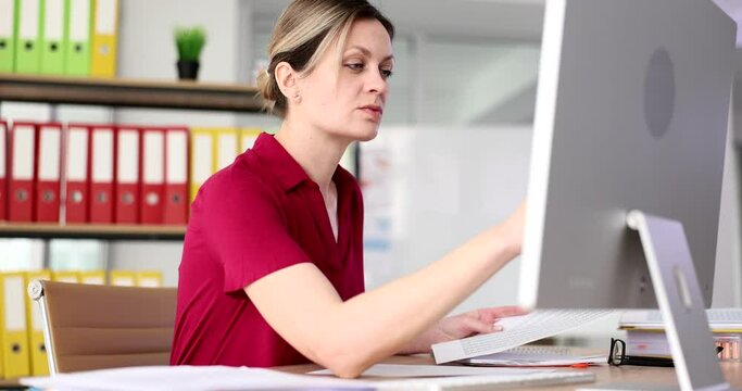Serious attentively business woman working with documents and computer in fose.Manager analyzing project results and writing notes