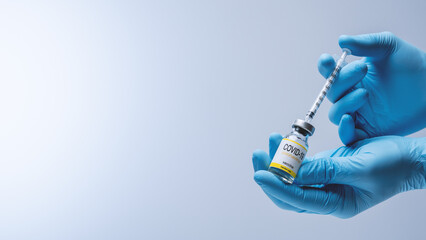 Doctor in blue latex gloves fill in syringe with vaccine from glass vial. Vaccination,...