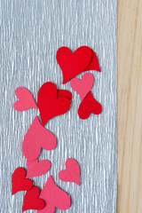 mess of wooden heart embellishments on crepe paper and wood