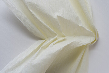 ivory white crepe paper stretched and crinkled on blank paper