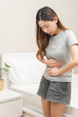 Flatulence ulcer, asian young woman, girl hands in belly, stomach pain from food poisoning, abdominal pain and digestive problem, gastritis or diarrhea. Abdomen inflammation, menstrual period people.