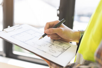 Building inspection asian contractor young man, male inspecting home, reconstructed construction, renovation or check defect, before finish handing it over to client, customer. Engineering worker.