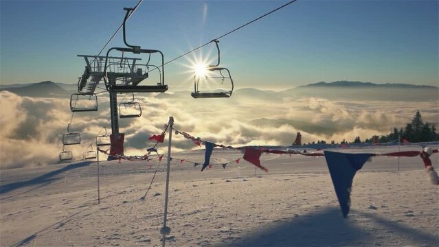 Empty chairlift in ski resort in beautiful sunny morning nature in winter skiing season slow motion