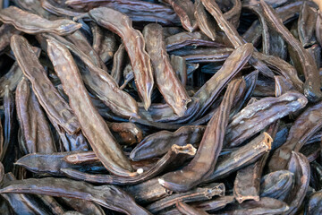 dried carob sold openly in the market,