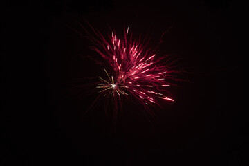 Burst of red fireworks at night - vibrant red streaks and sparks - smoke clouds - celebration, new years day, fourth of july, canada day. Taken in Toronto, Canada.