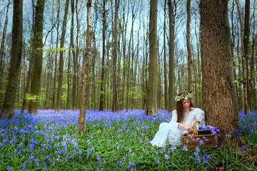 Victorian woman in bluebells forest