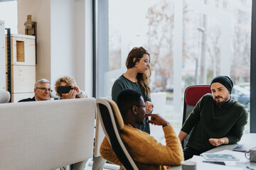 Obraz premium Diverse employees discussing strategies and sharing ideas in a modern office. Their teamwork promotes creativity and networking for successful projects.