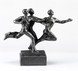 A purchased (consumer) figurine of runners made of cast iron in close-up on a white background