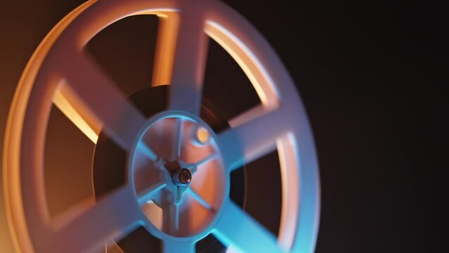 White film reels rotating. Old-fashioned 8mm movie projector playing bobbin tape in smokey dark at home theater.