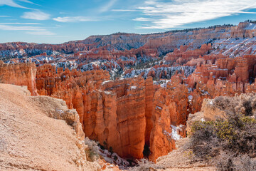 Fototapeta na wymiar Bryce canyon national park in winter, unique rock formations in utah covered in snow, orange rocks in snow, cold winter in the usa