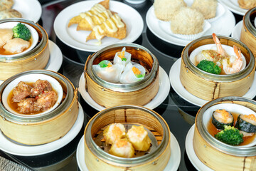 The Chinese food ,A many kind of Dim Sum in bamboo basket on table in chinese food restaurant.