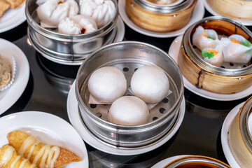The Chinese food ,A many kind of Dim Sum in bamboo basket on table in chinese food restaurant.
