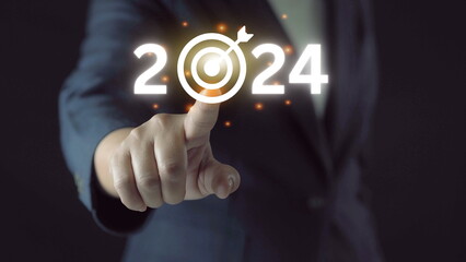 Obraz premium business target and goal on New year 2024 concept, hand holding 2022 virtual screen. new years business. new ideas coming up in the future.