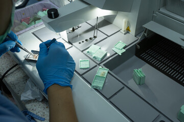 Fototapeta na wymiar The medical scientist is preparing a specimen for pathological examination in a hospital.