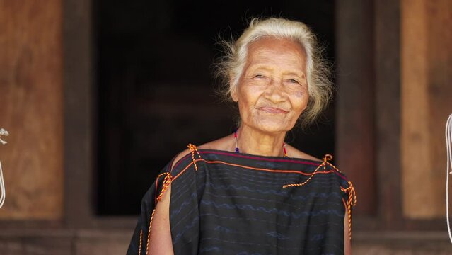 Portrait of smiling elderly woman in cultural attire, Flores, Indonesia, wrinkles