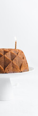Vanilla bundt cake on a white cake stand, homemade bundt cake on a white background