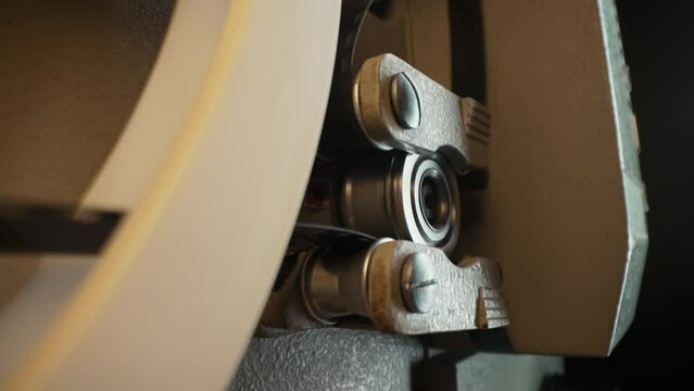 Macro working process of 8mm film projector rotating filmstrip reels. Mechanism 