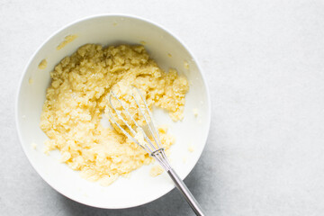 Creaming butter and sugar with a whisk, the process of making a cake, mixing butter and sugar to make a cake