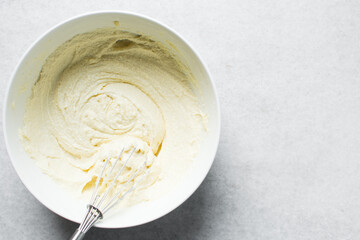 Creaming butter and sugar with a whisk, the process of making a cake, mixing butter and sugar to make a cake