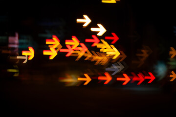 Traffic lights and cars lights blurred into turning arrow icon