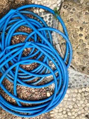 Water hose on the gravle stone floor.