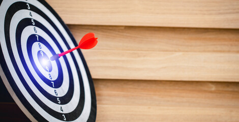 Red dart hitting on the target center dartboard, Business targeting or goal success and winner...