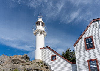 Lobster Cove Head Lighthouse at Gros Morne National Park in Newfoundland, Canada. Overlooking the...