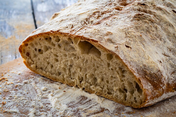 Loaf of homemade, fresh baked cottage bread on wooden table

