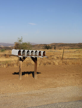 Row of open mailboxes in a rural setting