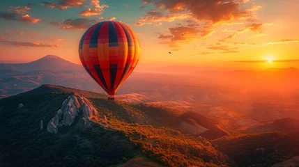 Gordijnen Turkish mountainous landscape with a majestic hot air balloon soaring amidst the setting sun's golden glow, casting vibrant hues over the peaks Generative AI © vadosloginov
