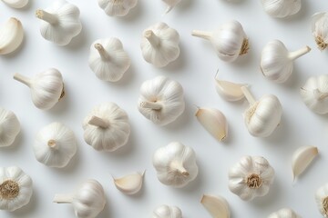 garlic with a brokenup clove near the white background.