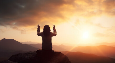 Christian Praying to God and Jesus: Hands Together under Red Sunset Sky and Bright Sunlight
