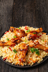 fried chicken drumsticks over rice pilaf, top view