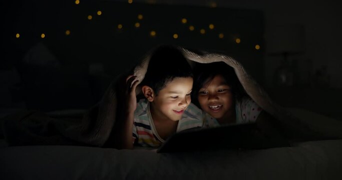 Tablet, night and children on bed with cartoon, gaming or streaming movie, video of film in blanket fort. Family, siblings or kids in bedroom with love, bonding or digital, search or storytelling app