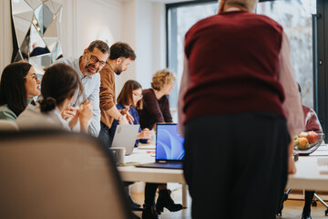 Engaged coworkers in a dynamic office environment sharing ideas and laughter.