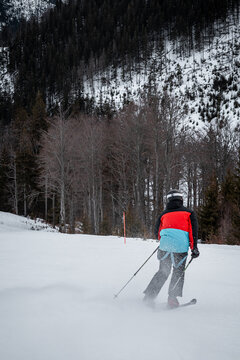 skier on a ski slope during a sunset with colorful sky
