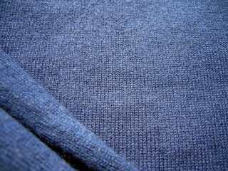 Dark blue cashmere. Dark wool natural fabric. Fabric texture. Knitwear.